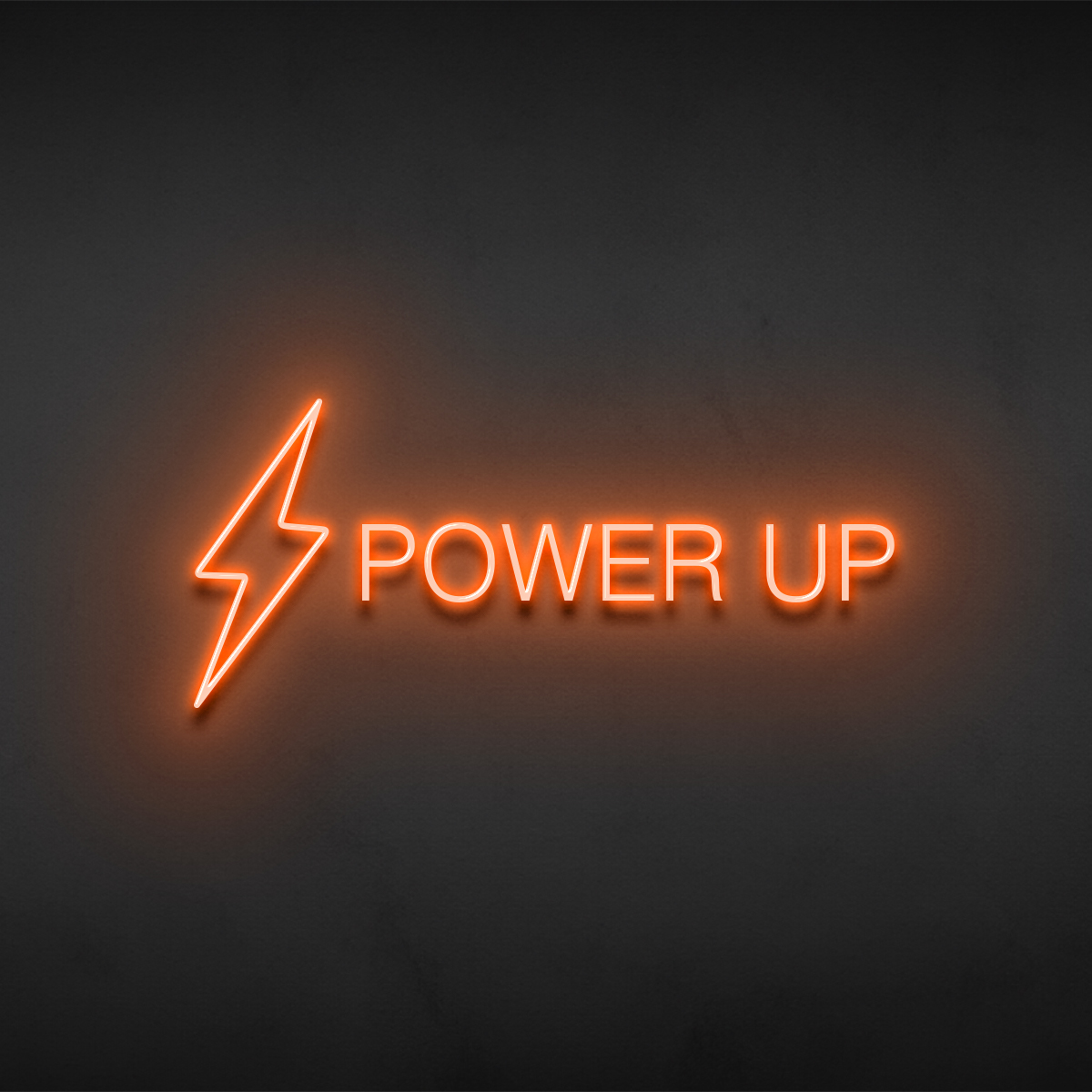 Power Up statement sign rendered in neon on a dark wall